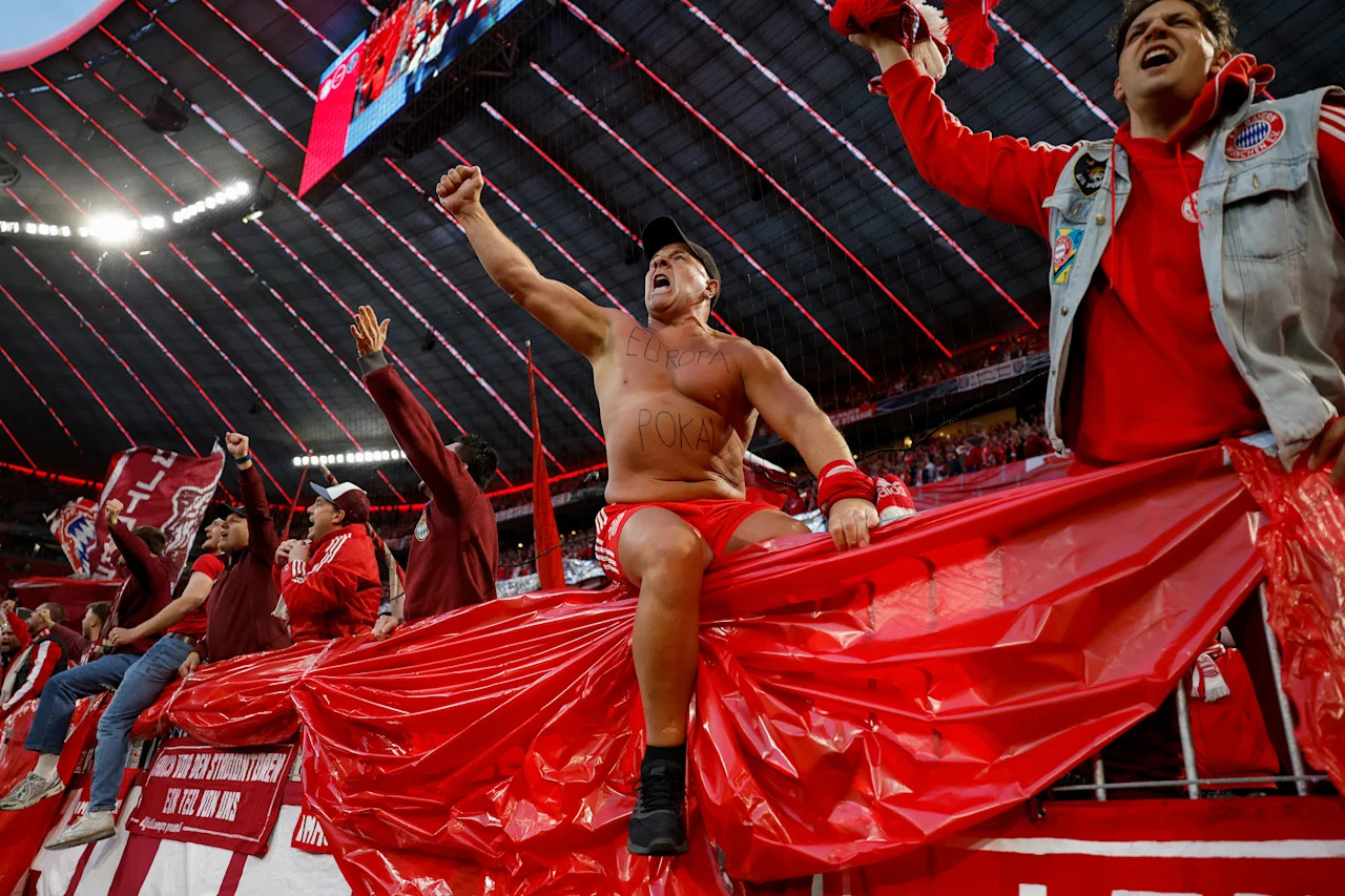 TOPSHOT - Bayern Munich fan cheer on their team prior to the UEFA Champions League second-leg, semi-final football match between FC Bayern Munich and Paris Saint-Germain (PSG) in Munich, southern Germany on May 6, 2026. (Photo by Odd ANDERSEN / AFP via Getty Images)