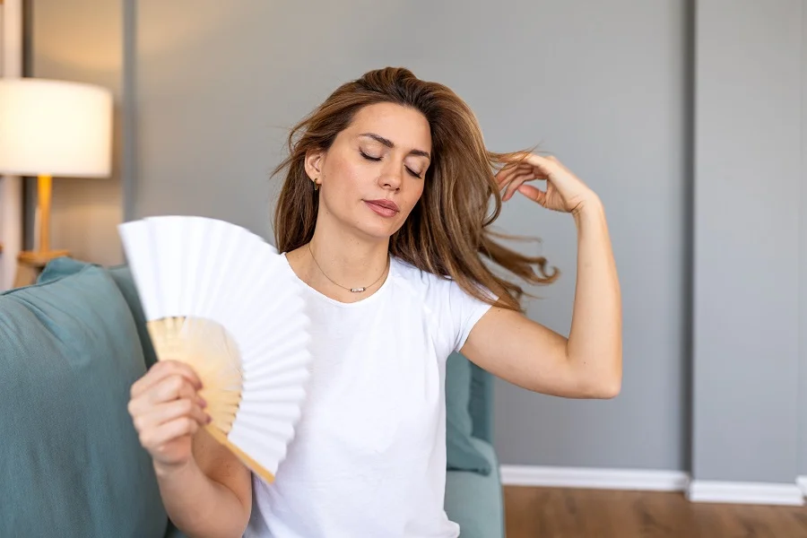 Middle aged woman fanning herself