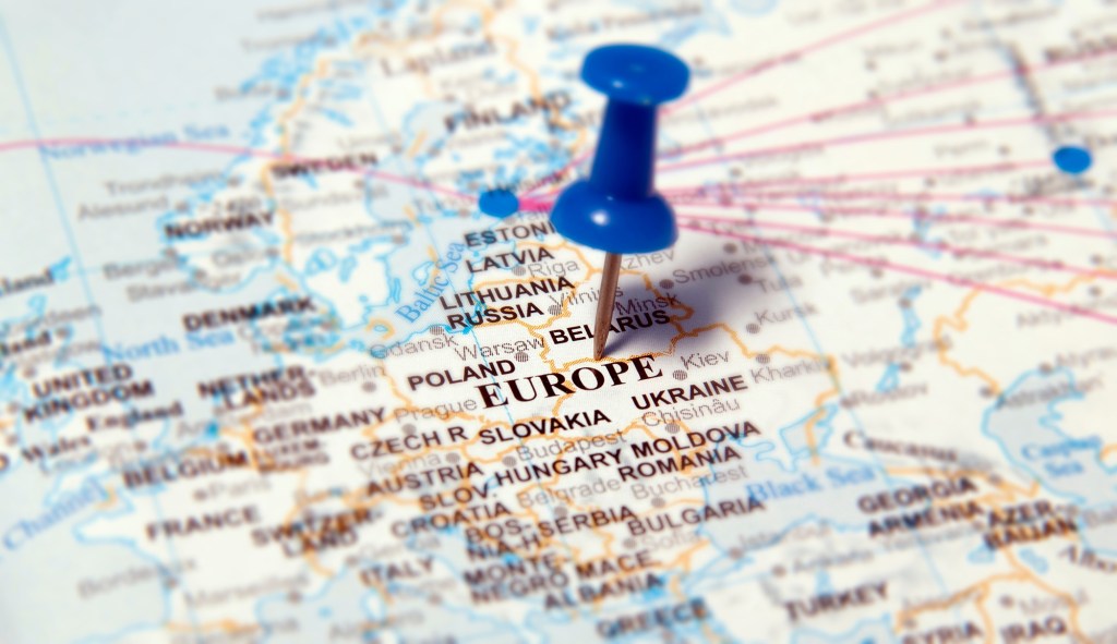 A blue pushpin marks the word "EUROPE" on a world map.