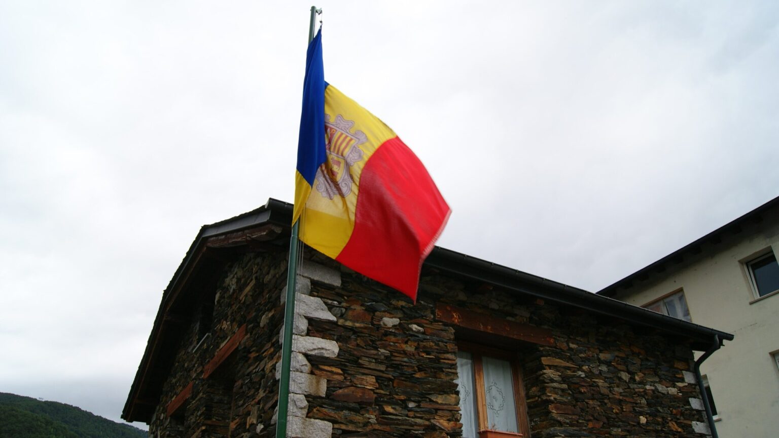 Andorra Tightens Nationality Rules with New Language and Residence Requirements ━ The European Conservative The Casa del Quart d’Anyós with the flag of Andorra