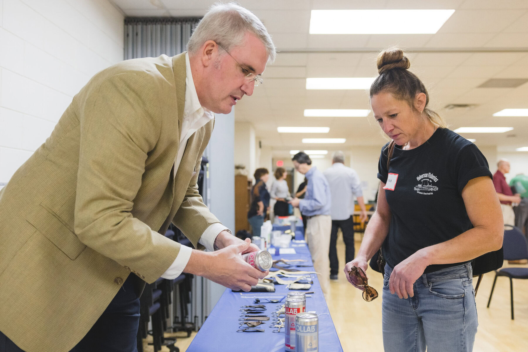 A man shows a woman products on a table.