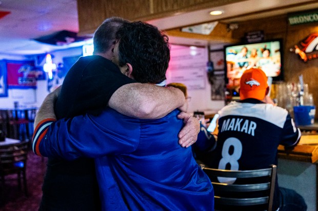 Key Largo regular, Kevin Edwards, left and bar owner, Sotirios Gatsiopoulos, right, hug each other before Gatsiopoulos leaves the bar at the end of his shift at Key Largo Lounge in Greeley on Wednesday, May 13, 2026. (Brice Tucker/Staff Photographer)