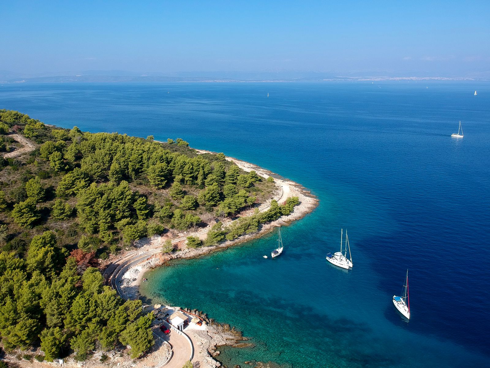 Image may contain Nature Outdoors Sea Water Shoreline Coast Boat Transportation Vehicle and Bay
