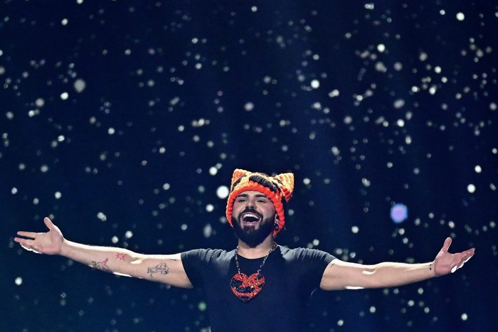 eurovision-2026-greece Akylas on stage with arms open wide smiling ahead.