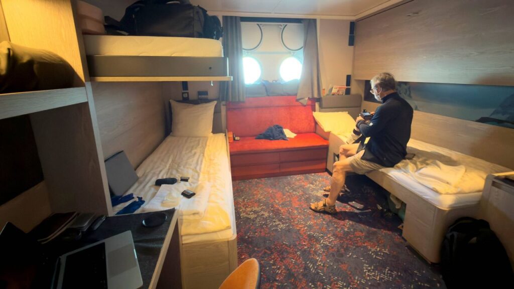 A passenger checks his camera inside his cabin on the hantavirus-stricken cruise ship, MV Hondius, during the voyage to Spain's port of Tenerife, May 6, 2026. (AP Photo)
