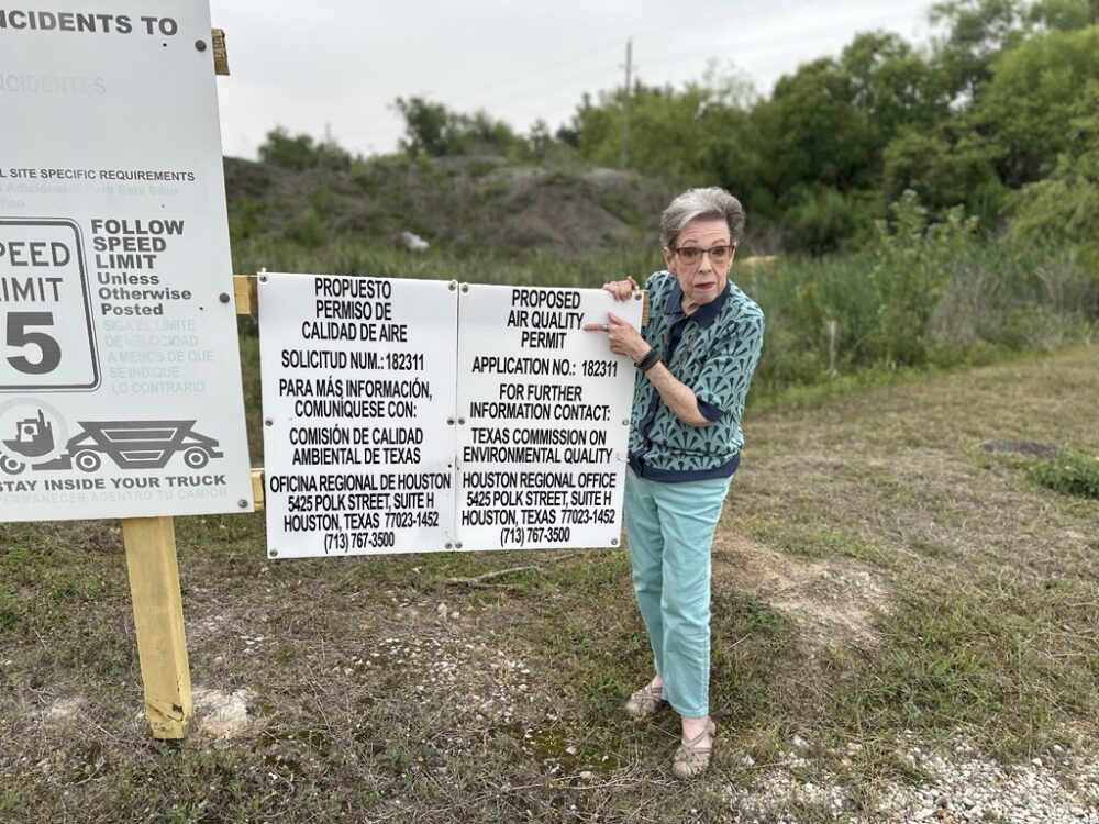Jayne Larkin, a Harris County resident, poses near a notice about a request for a permit for a concrete plant near her home.