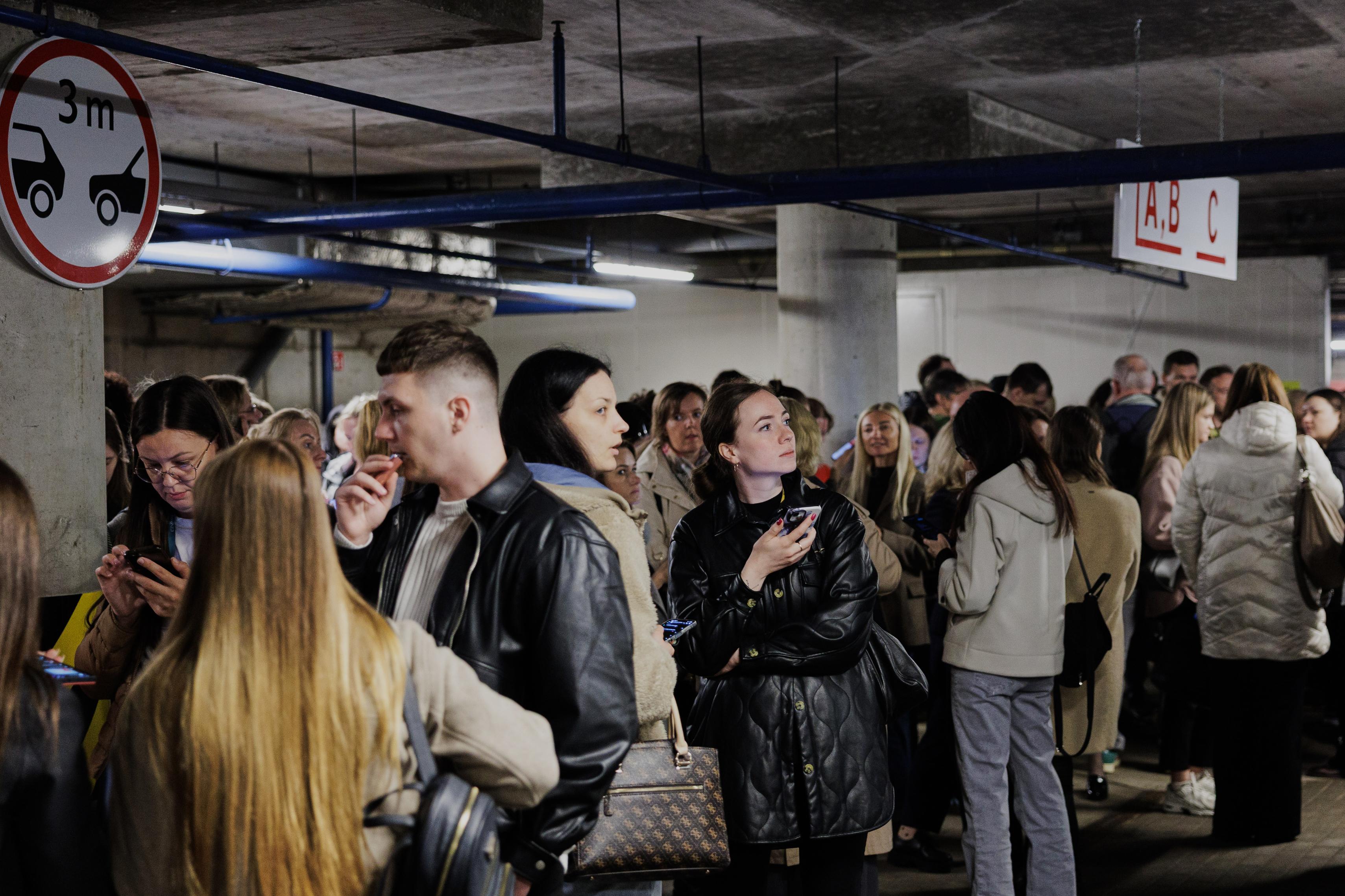 People take shelter in an underground car park