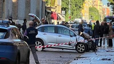 Police work at the scene after a driver injured eight people, four of them badly, when he drove on a sidewalk in Modena, Italy (AFP)