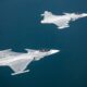Two Saab Gripen E fighter jets flying in formation Two Saab Gripen E fighter jets flying in formation