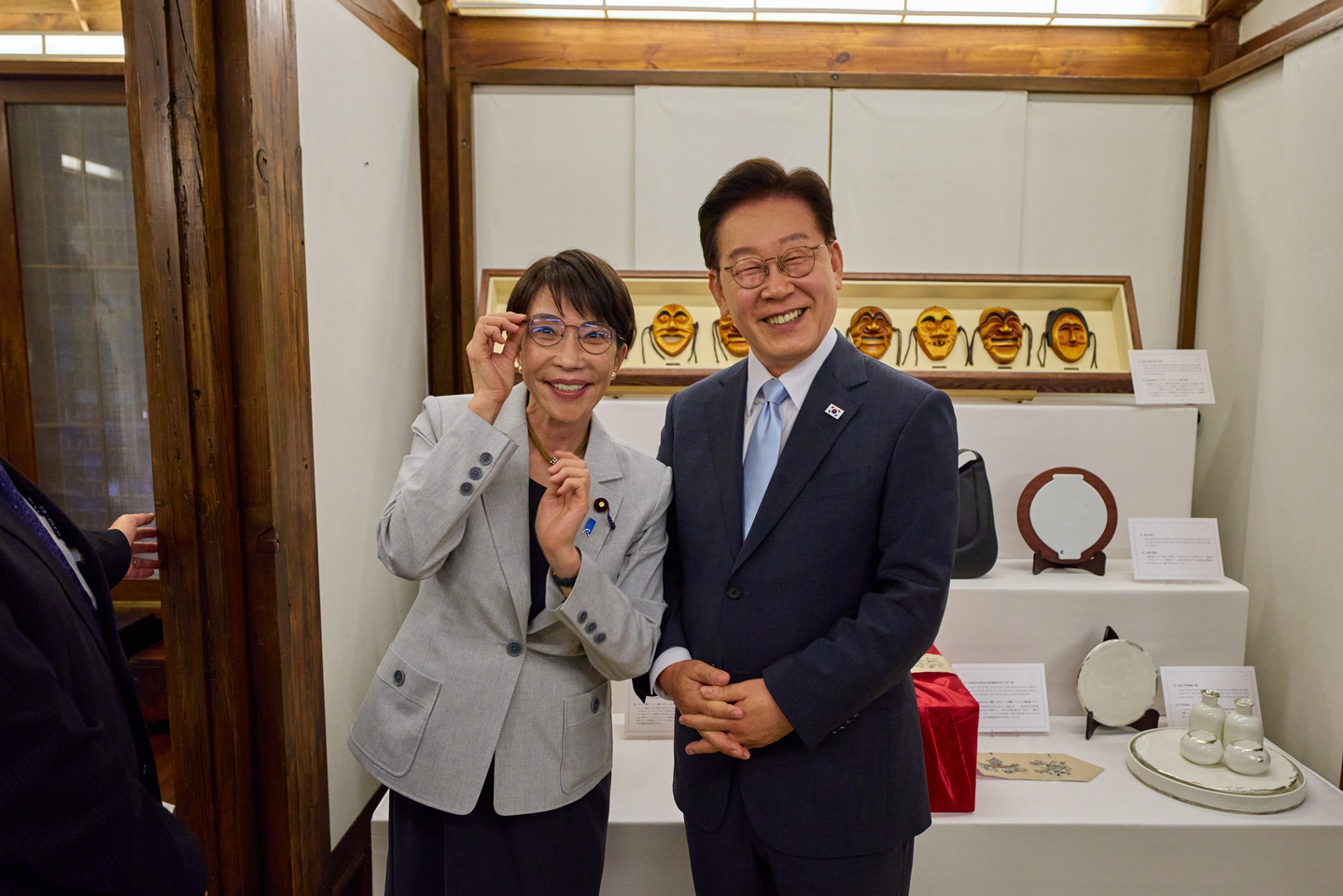 Korean President Lee Jae Myung, right, poses for a commemorative photo wearing eyeglasses gifted by Japanese Prime Minister Sanae Takaichi at a hotel in Andong in North Gyeongsang on May 19. Takaichi is wearing Lee's eyeglasses. [BLUE HOUSE]