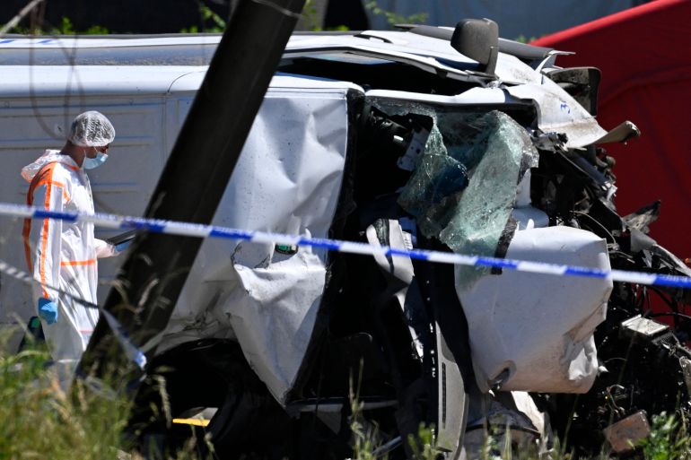 A Forensic Police officer inspects the damaged bus at the site of an accident after a train crashed into a school bus, at the railway crossing Vierhuizen in Buggenhout, some 20kms north of Brussels on May 26, 2026.