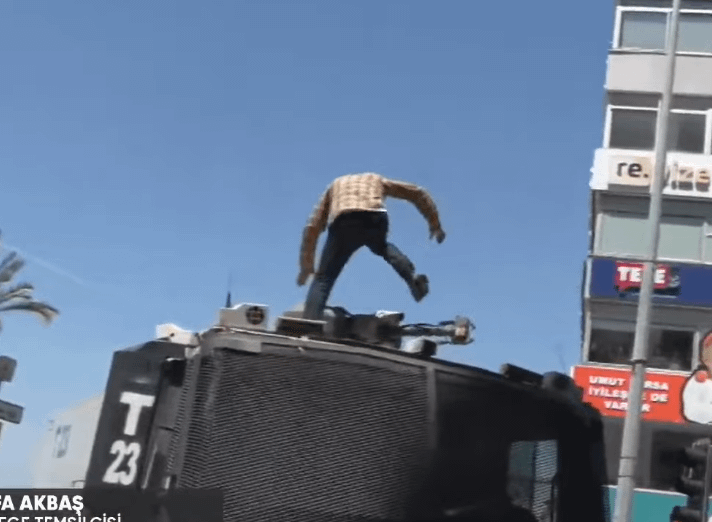 Police intervention at the rally area in Izmir. One man got on the tomb and broke it.