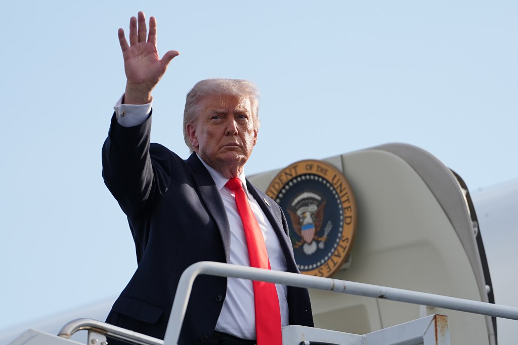 Donald Trump waves while boarding Air Force One.