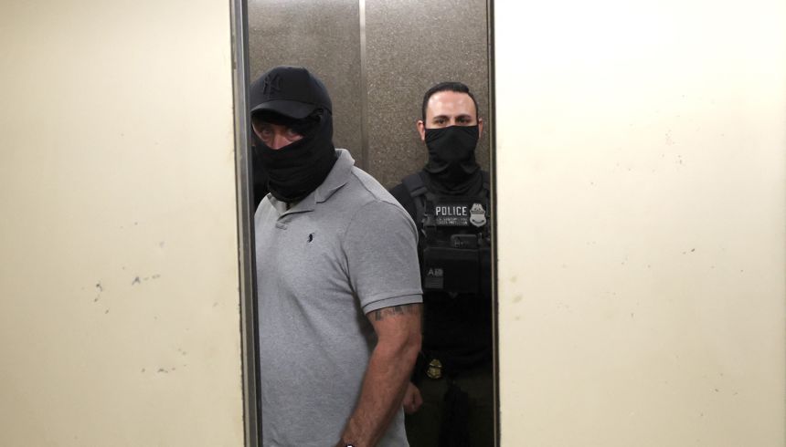 Federal agent wait in the hallway outside of a courtroom at New York Federal Plaza Immigration Court at the Jacob K. Javitz Federal Building on August 5, 2025 in New York City.