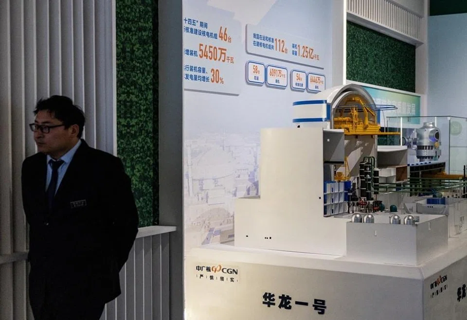 A member of security personnel looks on next to the display of Hualong One nuclear reactor, under the China General Nuclear Power Group, at an exhibition on China’s manufacturing achievements at the National Museum in Beijing, China, 24 March 2026.