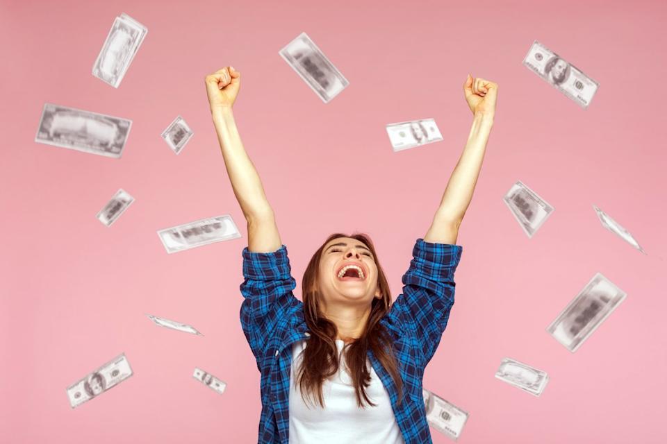 Investor celebrating a big win by throwing money into the air.