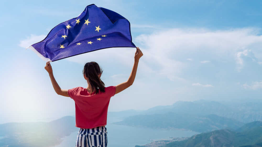A young girl waving an EU flag.