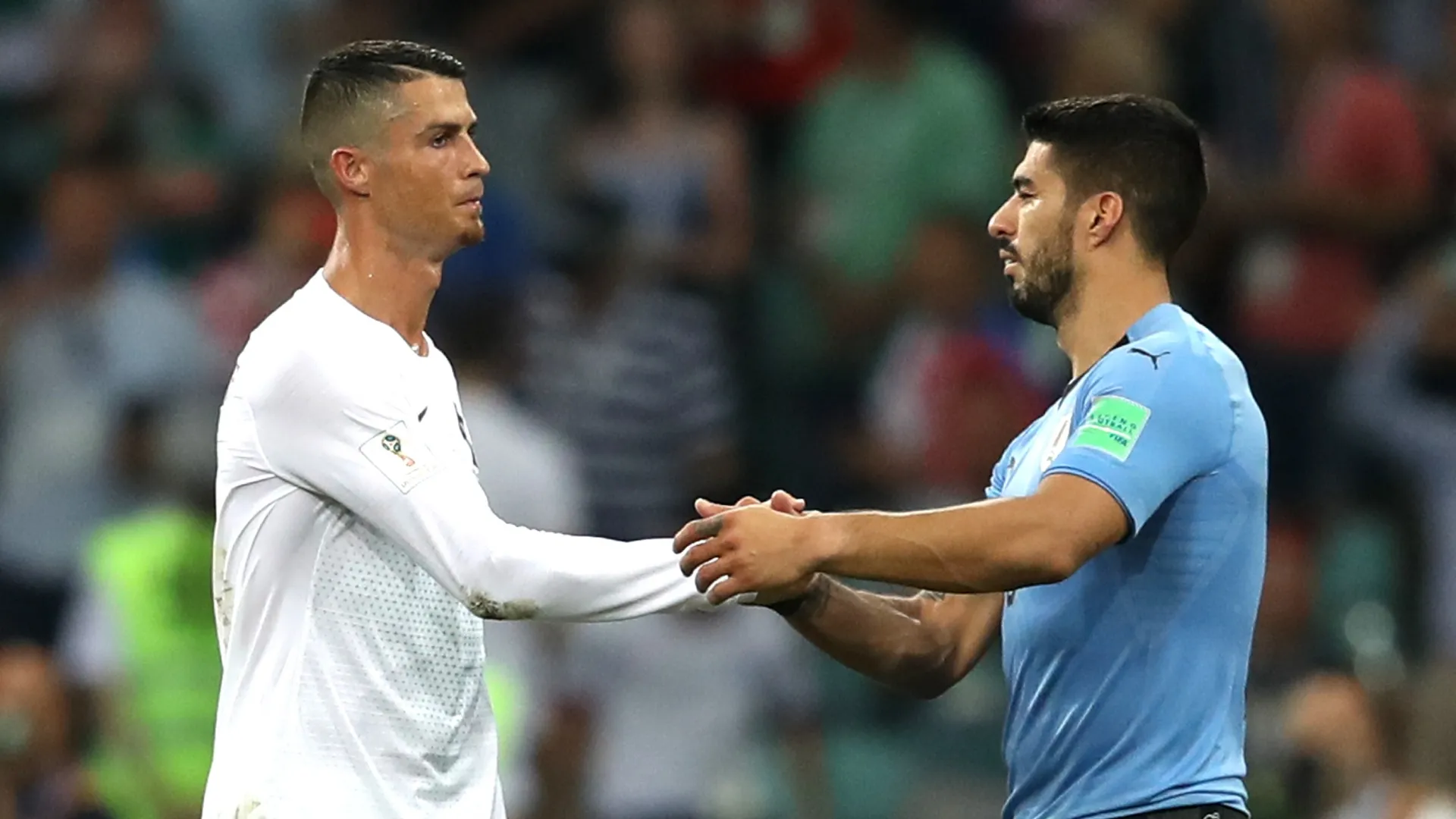 Luis Suarez of Uruguay shakes hands with Cristiano Ronaldo of Portugal.