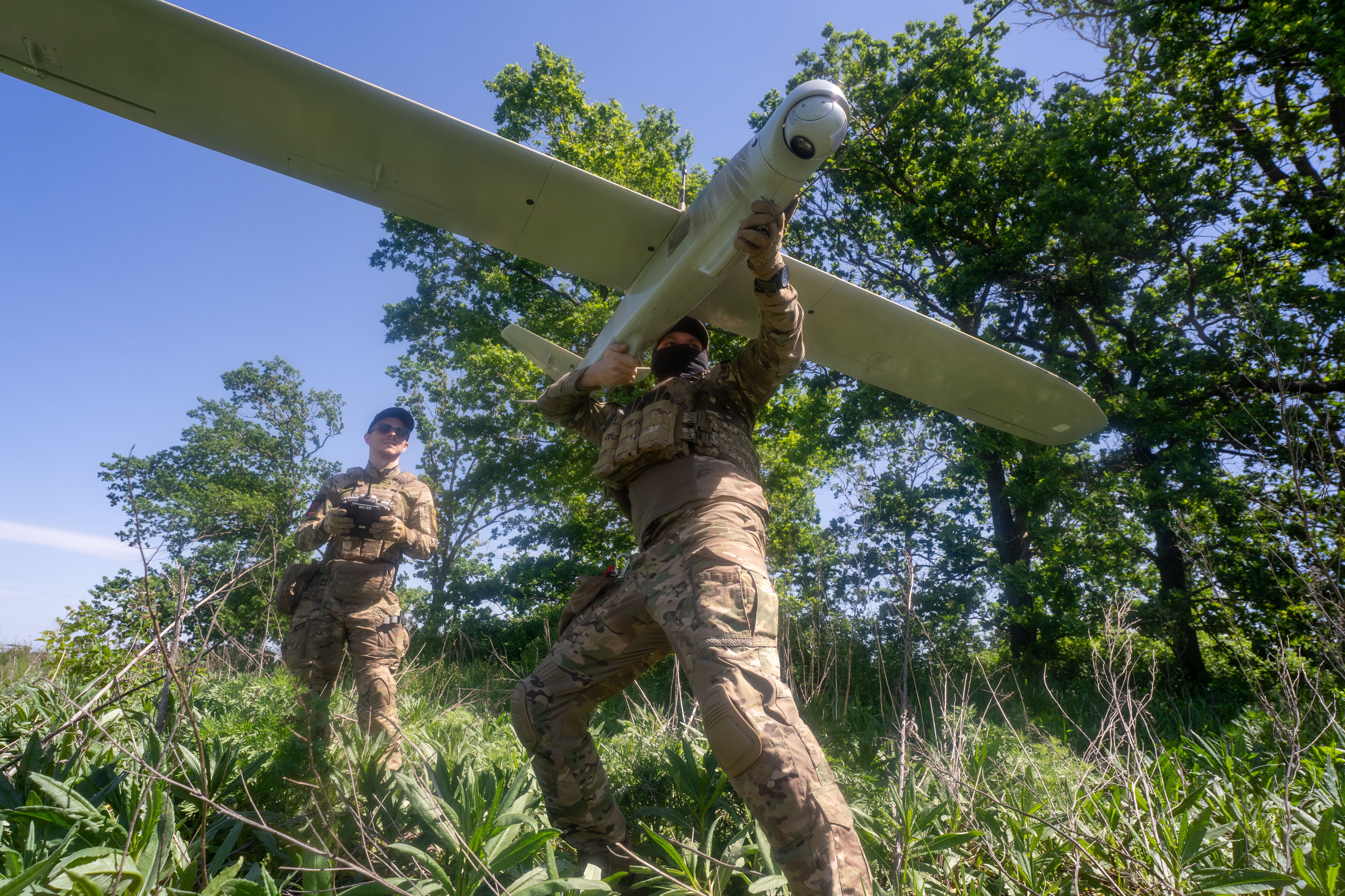 Ukrainian servicemen launch a drone towards Russian positions at the front line in the Kharkiv region of Ukraine