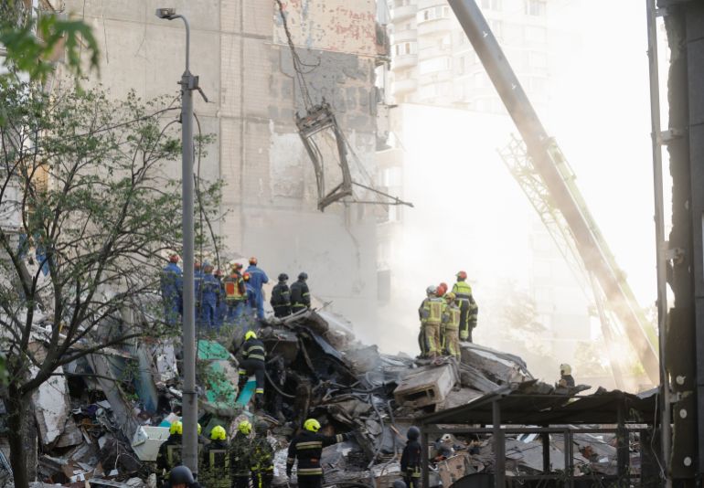 epa12956155 Ukrainian rescuers work at the site of a Russian strike on the nine-storey residential building in Kyiv, Ukraine, 14 May 2026, amid the Russian invasion. At least three people were killed, and ten people are missing, dozens of others (including a one-month-old baby) were injured after an overnight combined Russian attack with drones and missiles hit the Ukrainian capital, according to the State Emergency Service of Ukraine. EPA/SERGEY DOLZHENKO