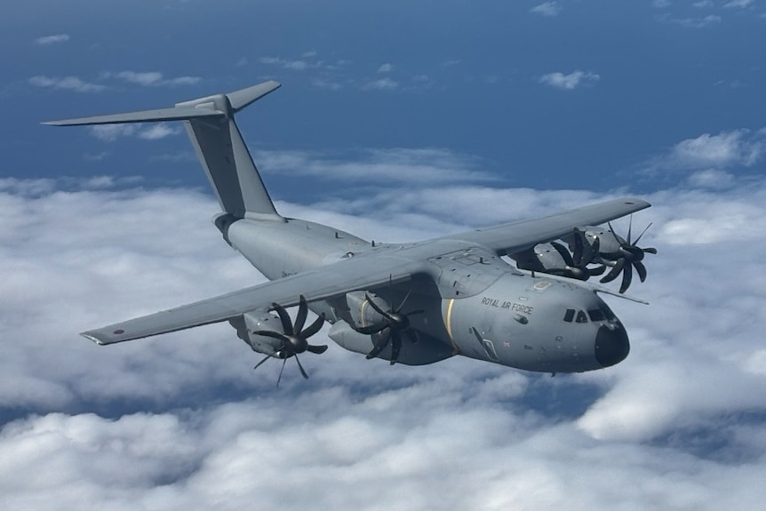 A Royal Airforce plane flying high above the clouds.