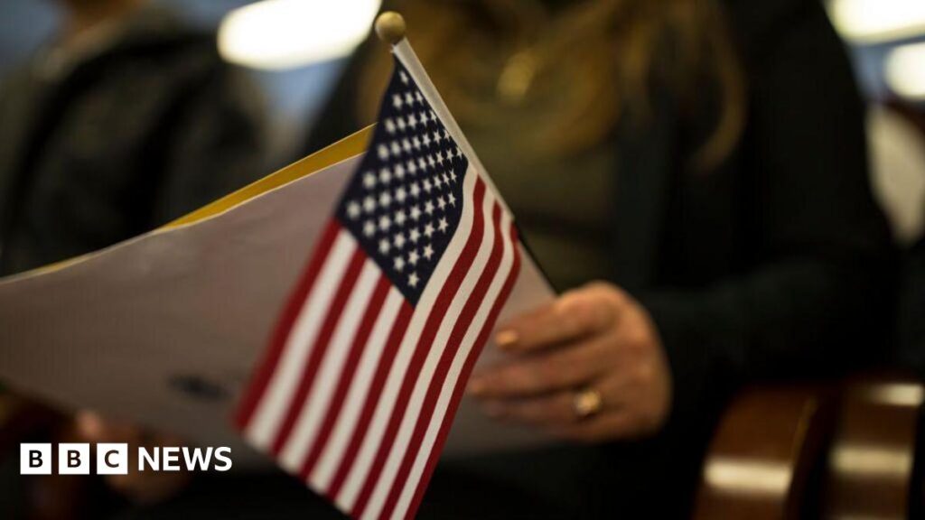 Most people seeking green cards must now apply from outside US A newly sworn in US citizen holds a US flag while listening to a speech from a US government employee at a naturalization ceremony for new US citizens February 16, 2017 in Newark, New Jersey
