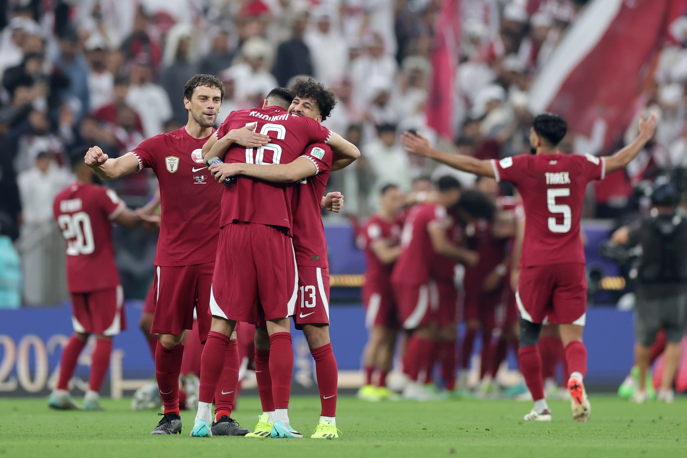 Boualem Khoukhi and Qatar celebrate victory over Jordan at the AFC Asian Cup final.