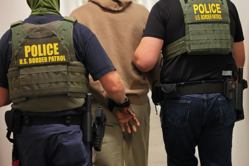 Federal agents detain a man after his court hearing in immigration court at the Ted Weiss Federal Building on July 9, 2025 in New York City.