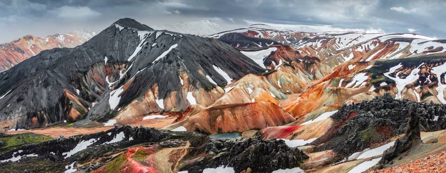 Colorful rhyolite mountains and snow patches create a vivid landscape in Landmannalaugar.