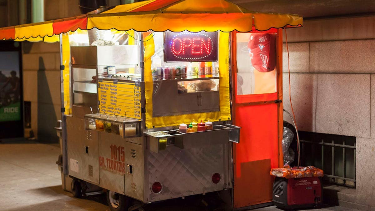 Hot dog stand illuminated at night in Toronto