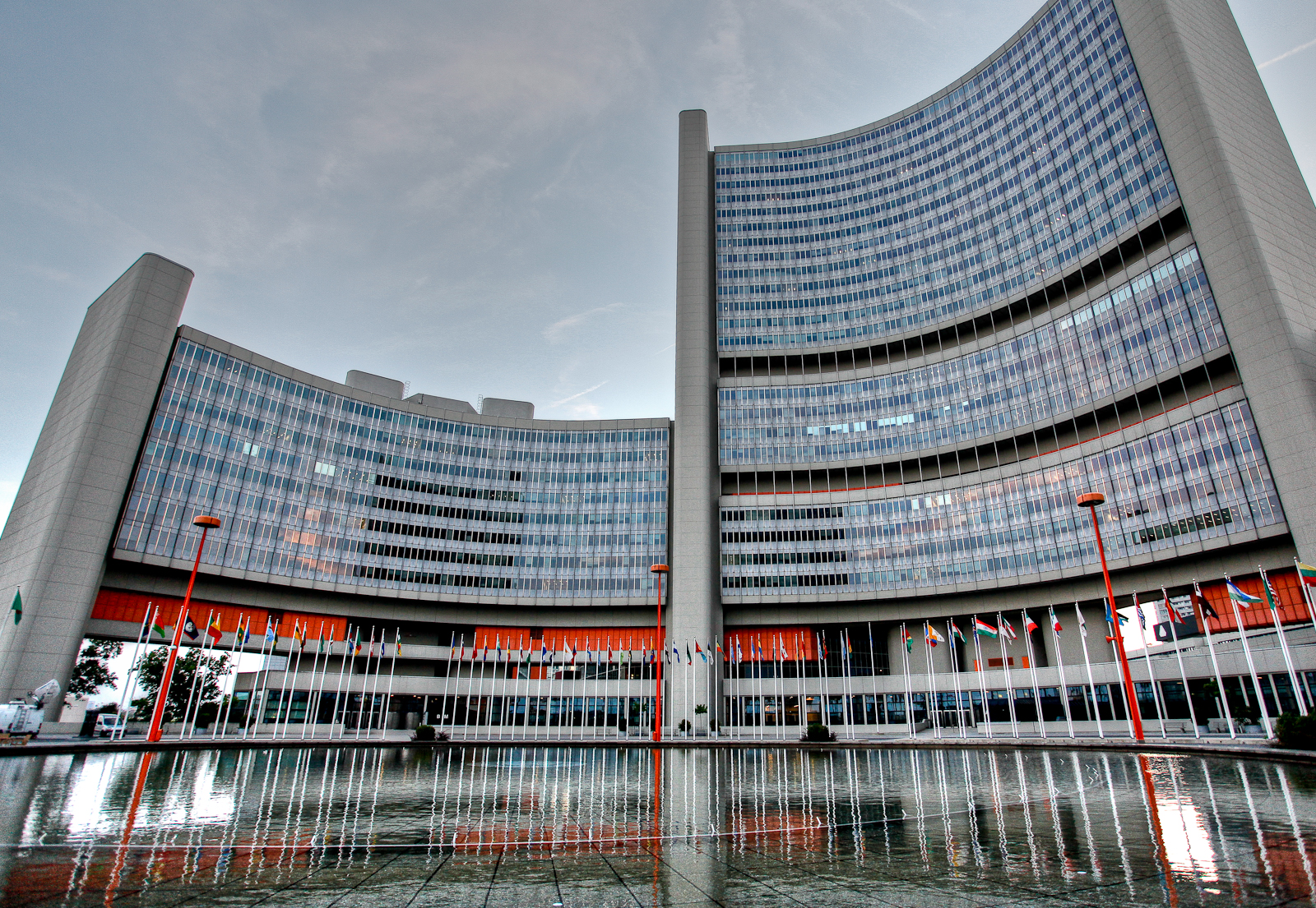 Vienna International Centre, headquarters of the IAEA, with curved glass towers and UN member state flags, Vienna, Austria