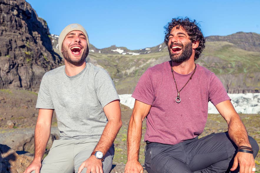 Two friends laughing outdoors in Iceland in April, capturing the playful spirit of April Fools’ Day. Two friends laughing outdoors in Iceland in April, capturing the playful spirit of April Fools’ Day.