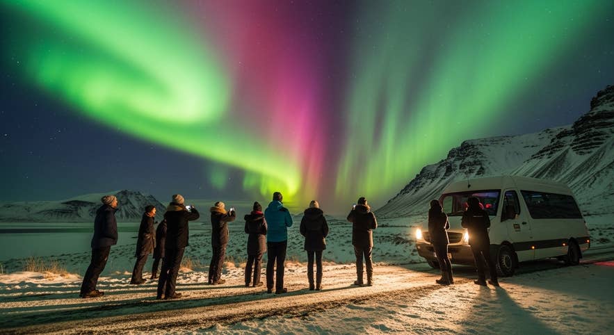 Tour group watching bright northern lights over snowy mountains, a highlight of Iceland in April. Tour group watching bright northern lights over snowy mountains, a highlight of Iceland in April.