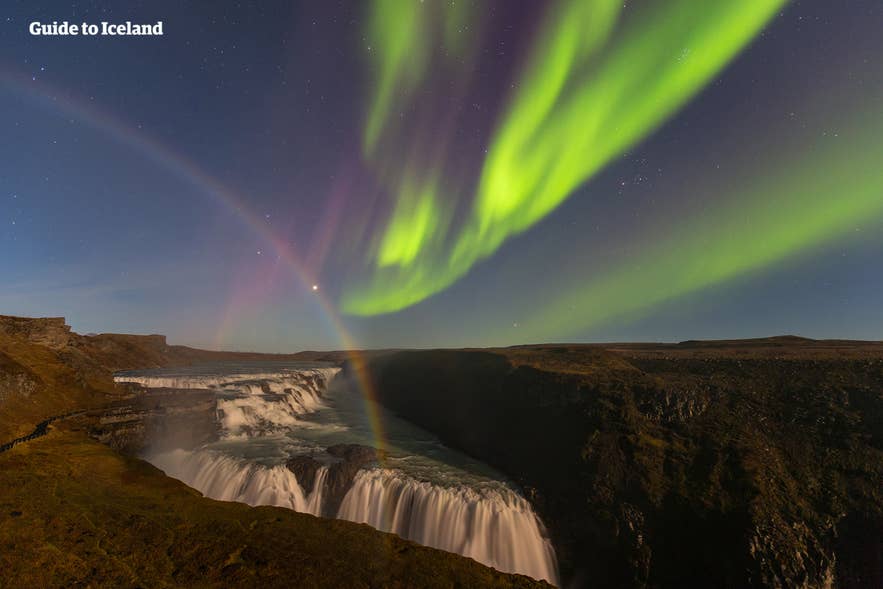 Northern lights over Gullfoss Waterfall in Iceland in April with a visible rainbow above the canyon. Northern lights over Gullfoss Waterfall in Iceland in April with a visible rainbow above the canyon.