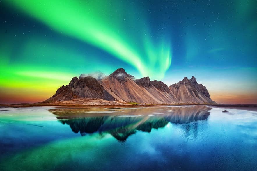 Northern lights over Vestrahorn Mountain, a view not possible in Iceland in June due to continuous daylight. Northern lights over Vestrahorn Mountain, a view not possible in Iceland in June due to continuous daylight.