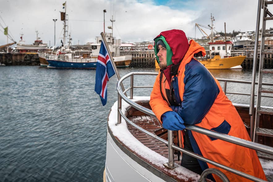 Man on fishing boat during Sjomannadagurinn in Iceland in June, celebrating Seafarers’ Day. Man on fishing boat during Sjomannadagurinn in Iceland in June, celebrating Seafarers’ Day.