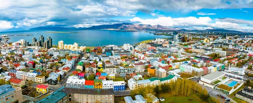Colorful aerial view of Reykjavik in Iceland in June, with clear skies, city buildings, and mountains by the sea. Colorful aerial view of Reykjavik in Iceland in June, with clear skies, city buildings, and mountains by the sea.