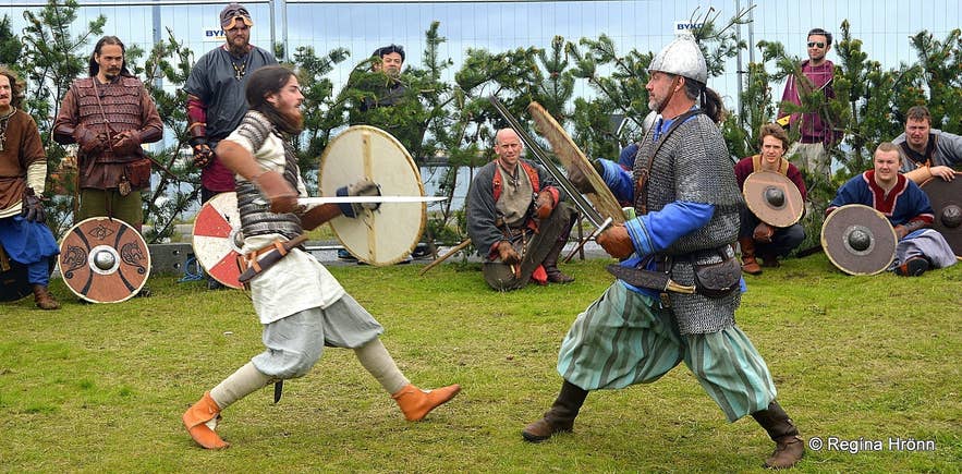 Live sword fight reenactment at the Viking Festival in Hafnarfjordur, Iceland in June, with costumed warriors and spectators. Live sword fight reenactment at the Viking Festival in Hafnarfjordur, Iceland in June, with costumed warriors and spectators.
