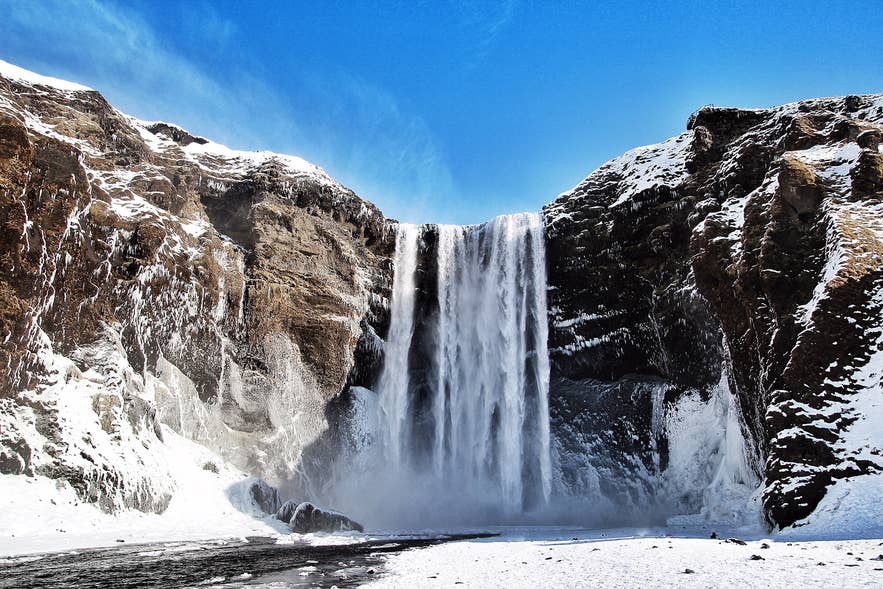 Skogafoss waterfall in South Iceland looks truly majestic during winter Skogafoss waterfall in South Iceland looks truly majestic during winter