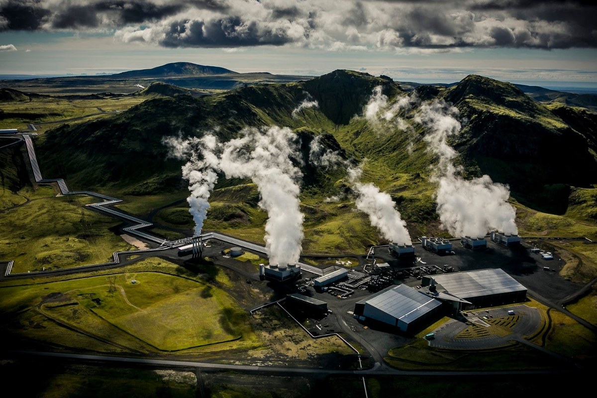 Geothermal plant in Iceland with steam rising from the volcanic landscape