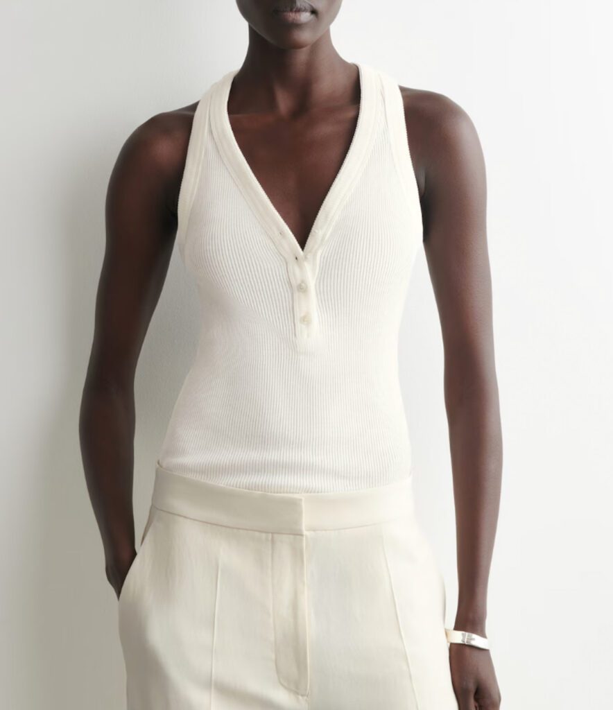 Cream ribbed knit halter top with V-neckline and button detail, paired with ivory wide-leg trousers – minimalist summer style for Croatia trip