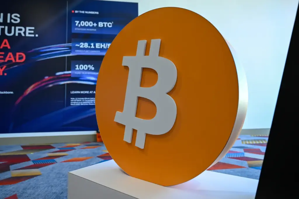 Bitcoin Traders Brace For PPI Data, CLARITY Act — Could ‘Go Both Ways’ For BTC, Says MN Fund Investment Chief Bitcoin logo displayed at a digital asset conference held in Las Vegas, Nevada, United States on April 28, 2026. (Photo by Tayfun Coskun/Anadolu via Getty Images)