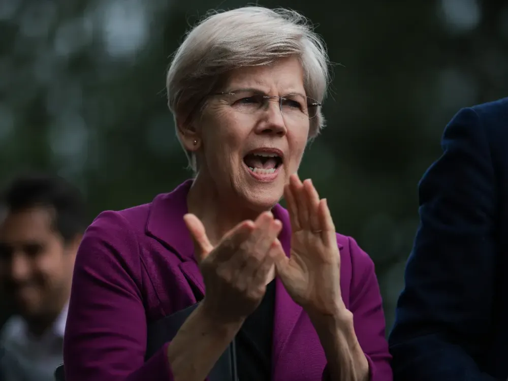Senator Warren Reportedly Slams OCC Crypto Bank Approvals For Ripple, Coinbase, Paxos, And Trump’s World Liberty Financial Sen. Elizabeth Warren (D-MA) claps during a press conference on social security in front of the U.S. Capitol on May 05, 2025 in Washington, DC. (Photo by Kayla Bartkowski/Getty Images)