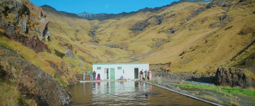 The couple in the movie Through Night and Day taking a dip in Seljavallalaug pool in Iceland The couple in the movie Through Night and Day taking a dip in Seljavallalaug pool in Iceland