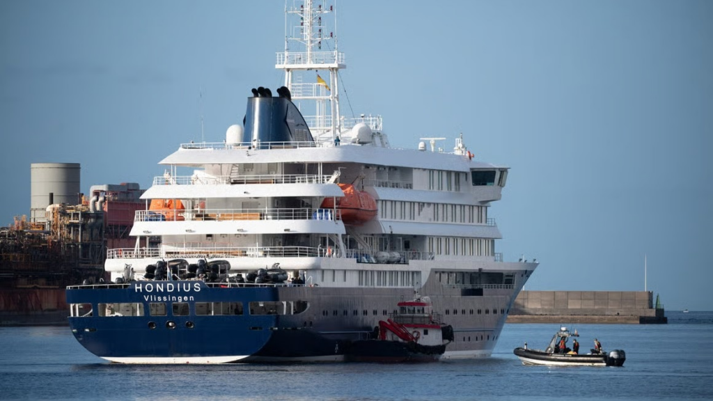 Health workers evacuate passengers from the hantavirus-affected cruise ship MV Hondius, docked near Spain's Canary Islands, and take them to hospital