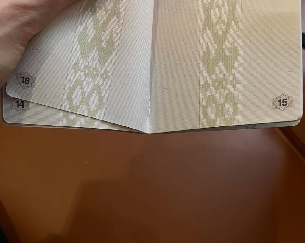 What to do in a situation where one of the pages was sewn on the wrong side when making a passport?