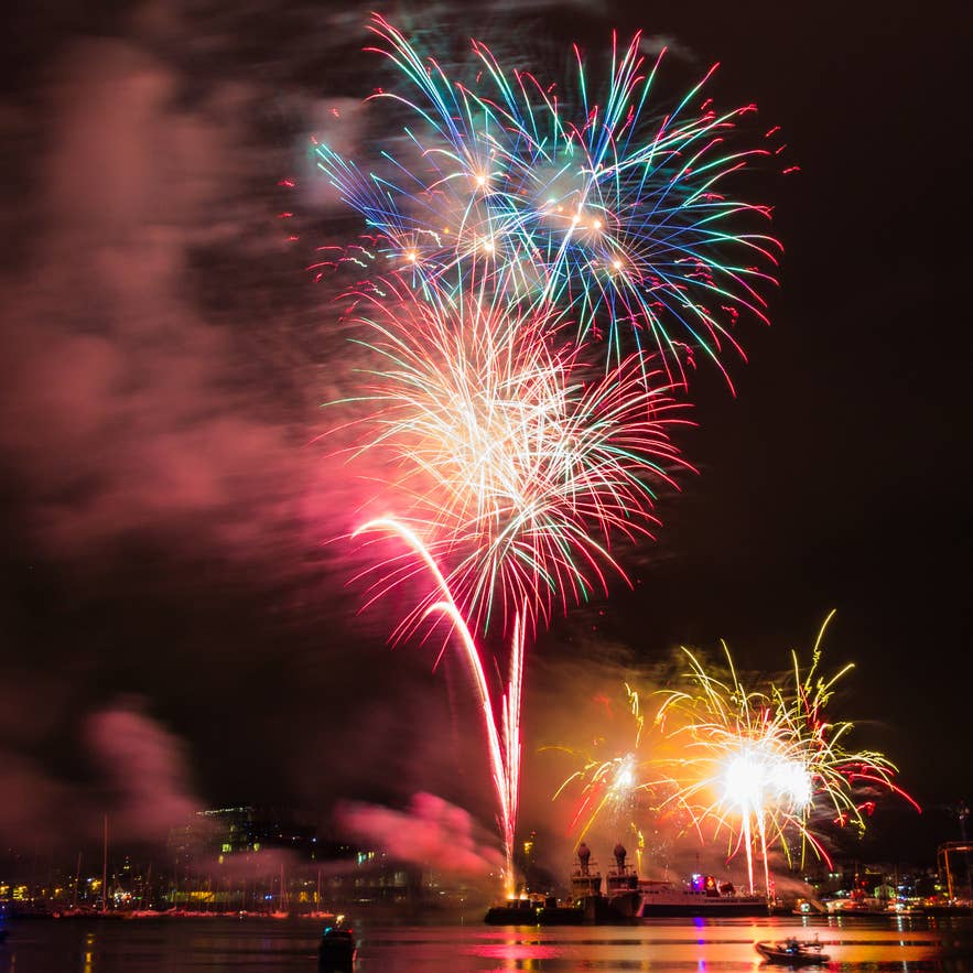 Colorful New Year’s Eve fireworks over Reykjavik harbor in Iceland, reflecting on the water Colorful New Year’s Eve fireworks over Reykjavik harbor in Iceland, reflecting on the water