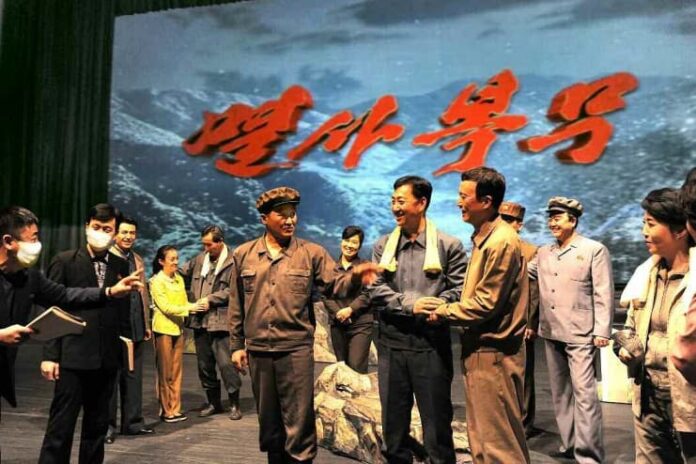 north-korea-state-theater-company-production-stage Performers and production staff from North Korea's State Theater Company on stage during a production