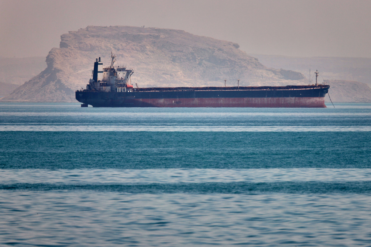 A bulk cargo ship sits at anchor in the Strait of Hormuz