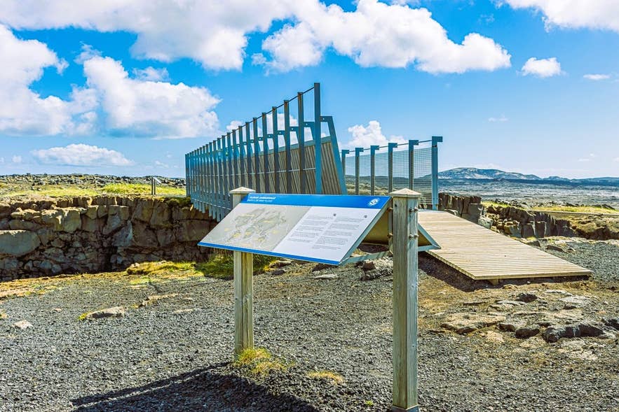 Information sign and footbridge at the Bridge Between Continents on the Reykjanes Peninsula Information sign and footbridge at the Bridge Between Continents on the Reykjanes Peninsula